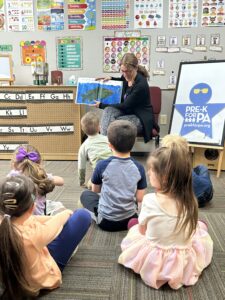 Representative Tarah Probst reading to children. 